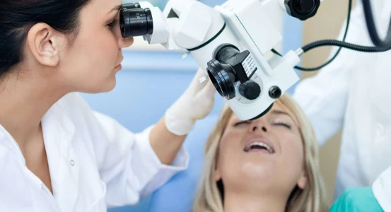 photo of dental treatment with a dental microscope