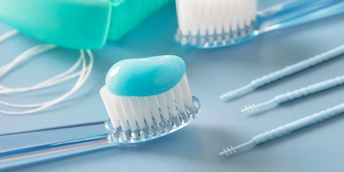 photo of a toothbrush with toothpaste and other oral care items